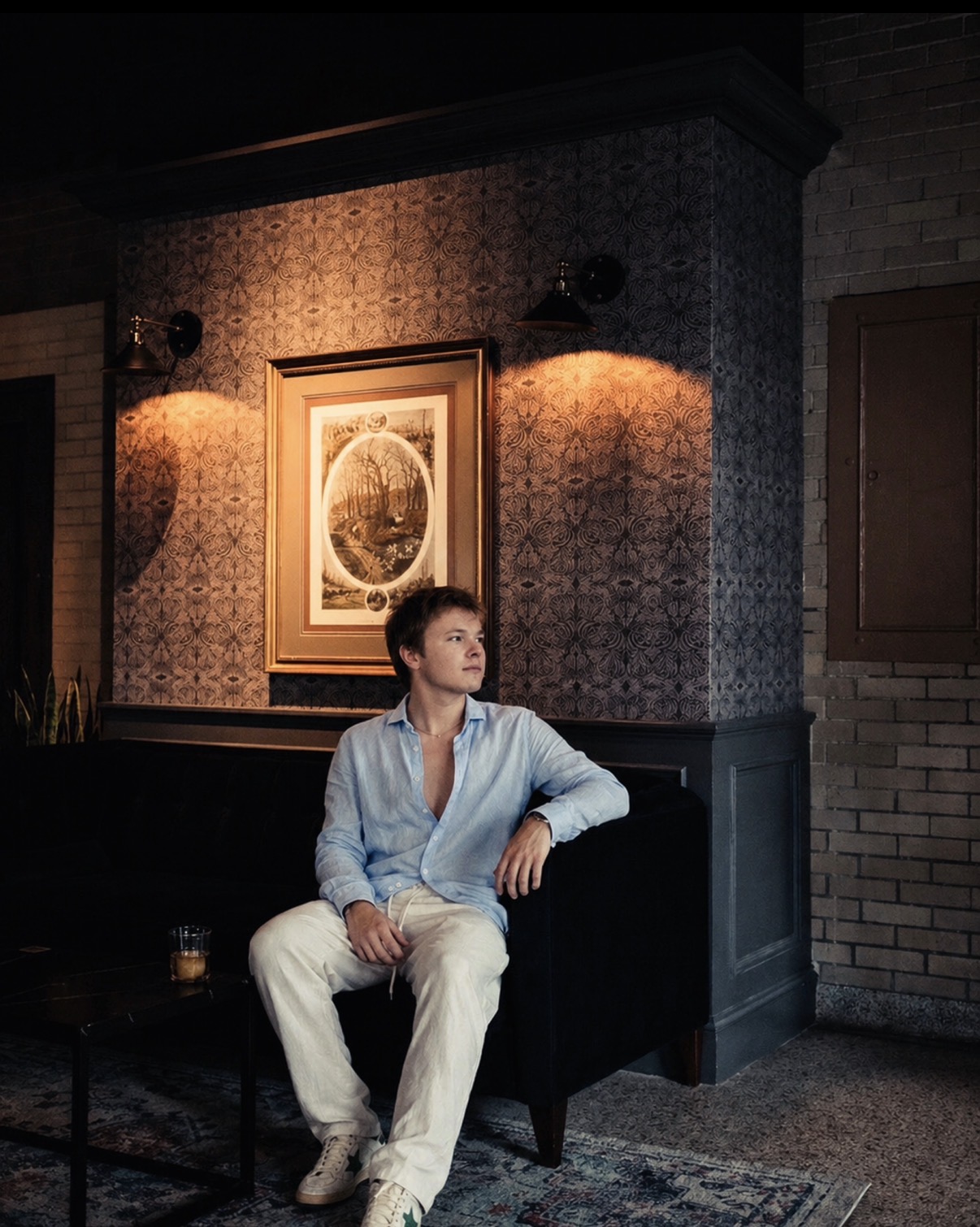 Portrait of Will Pruitt seated in a warmly lit interior